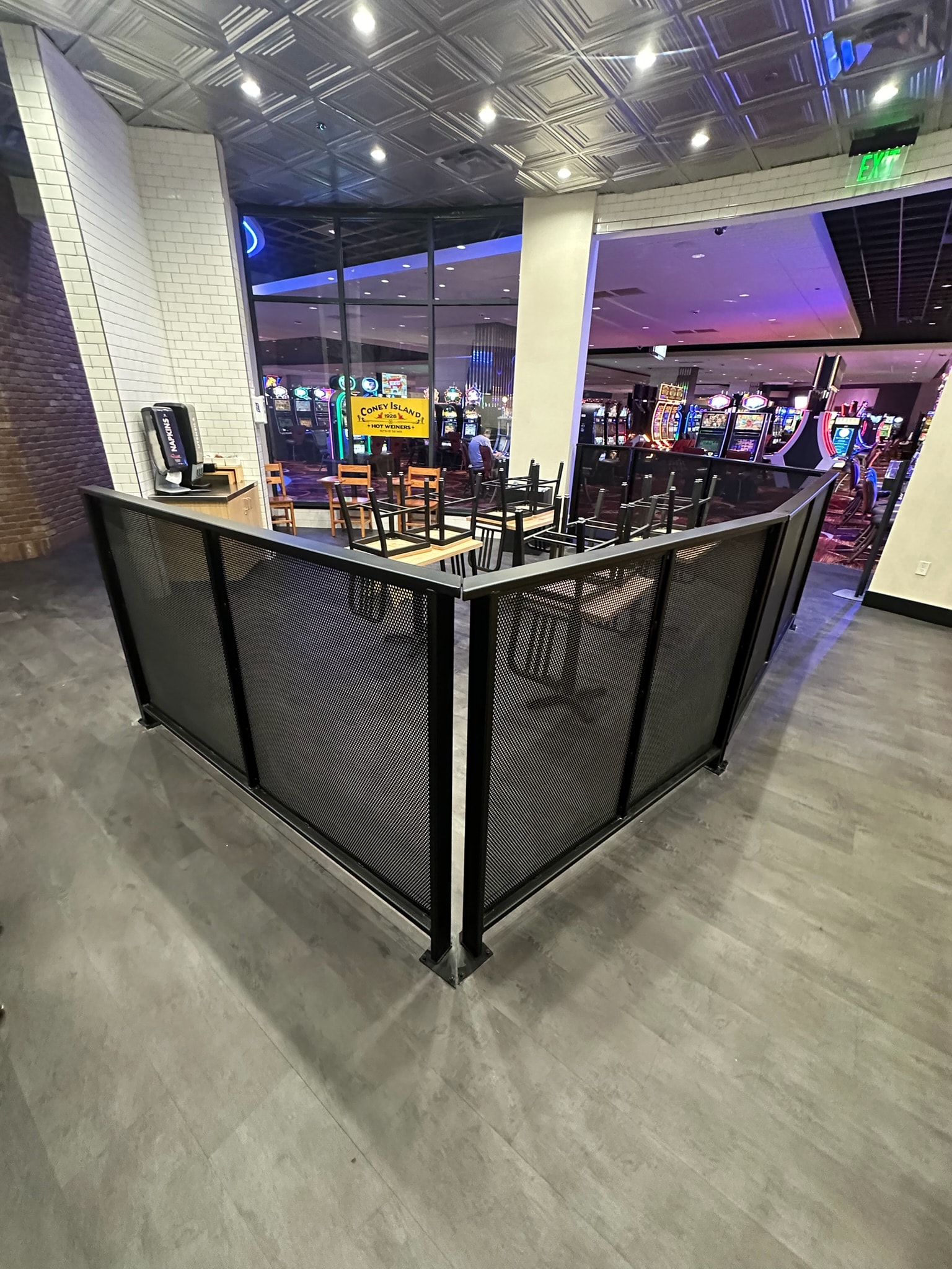 Black perforated metal partition fabricated for a casino dining area