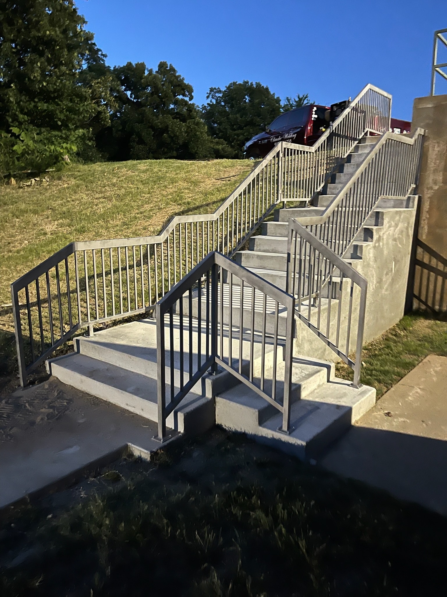 Commercial concrete staircase with custom black steel safety railings
