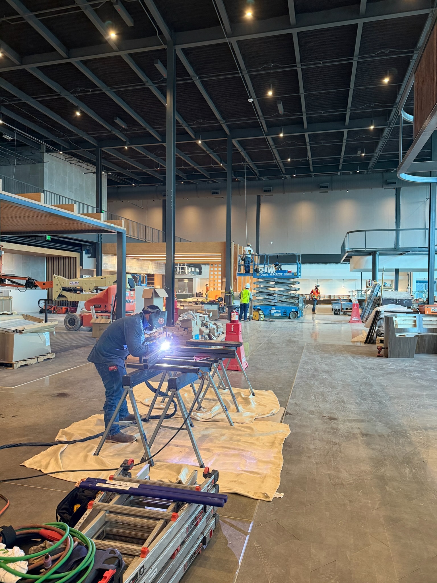 Field welding underway inside a large commercial interior