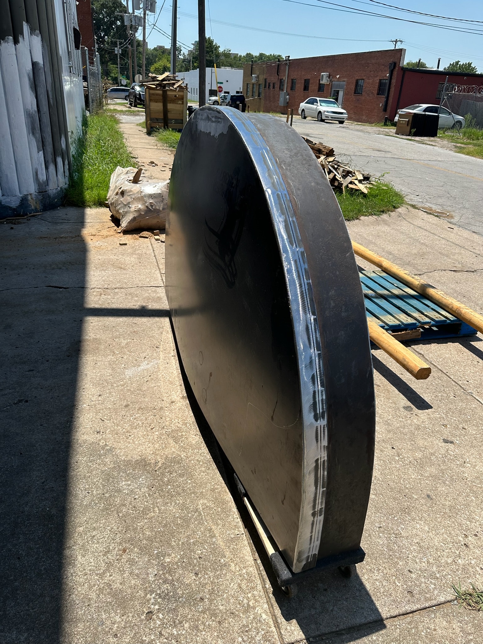 Curved steel vessel component prepared for fabrication outdoors