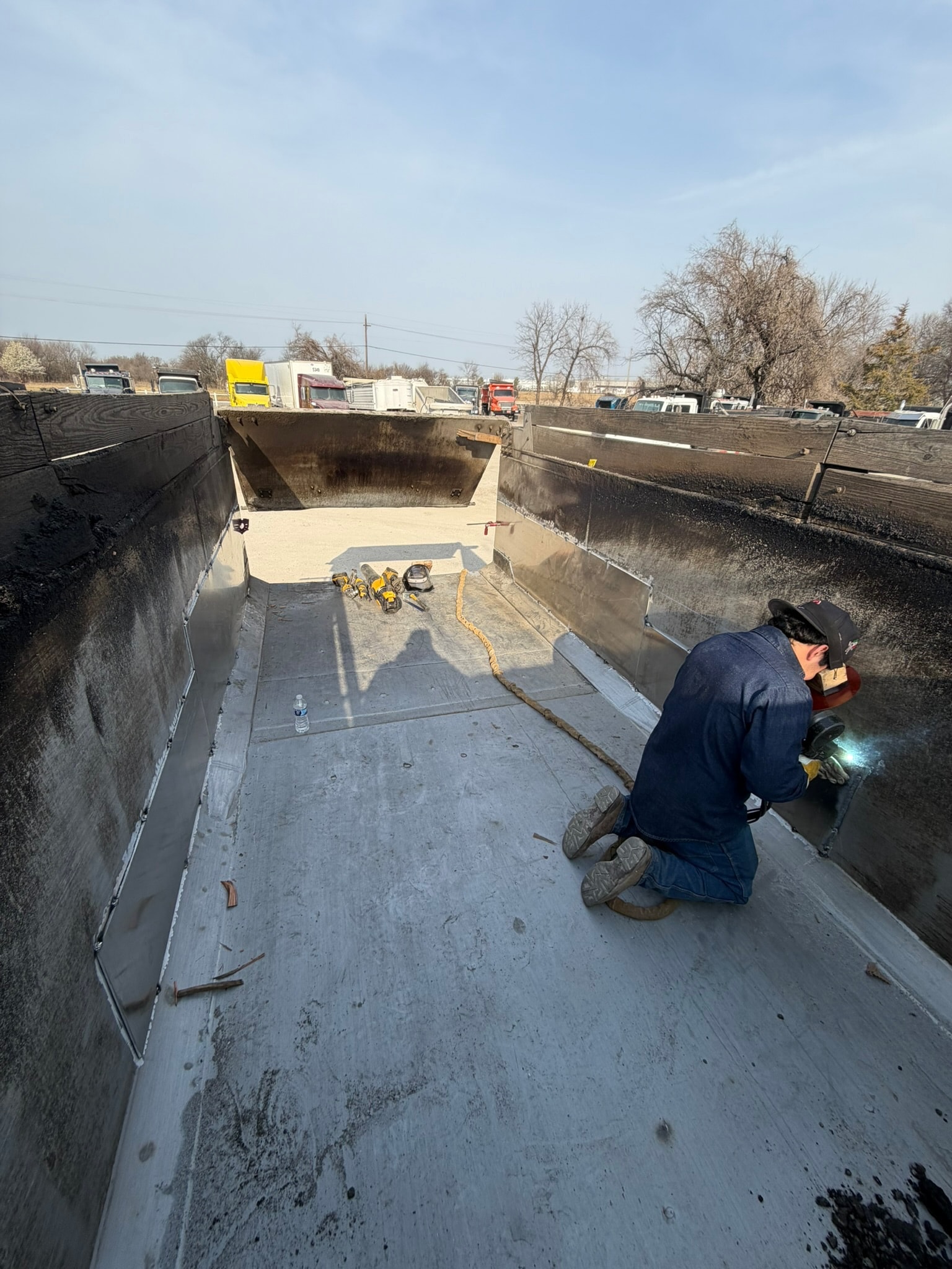 Field repair welding inside a heavy-duty dump trailer