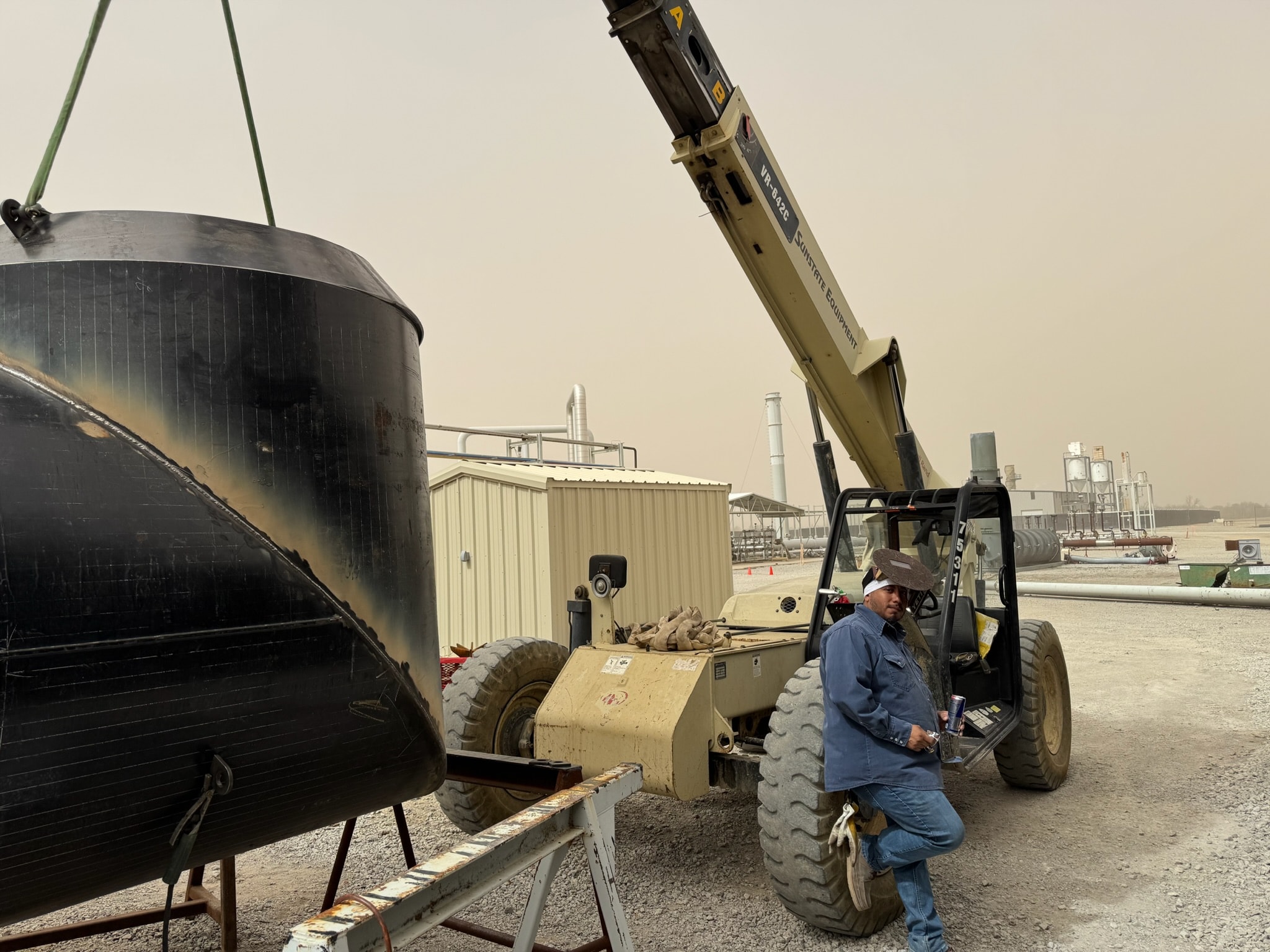 Heavy industrial steel vessel being positioned with lifting equipment