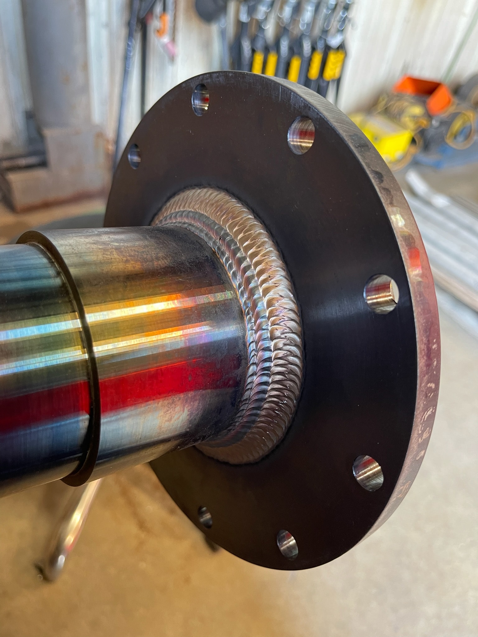 Precision pipe flange weld with polished steel finish