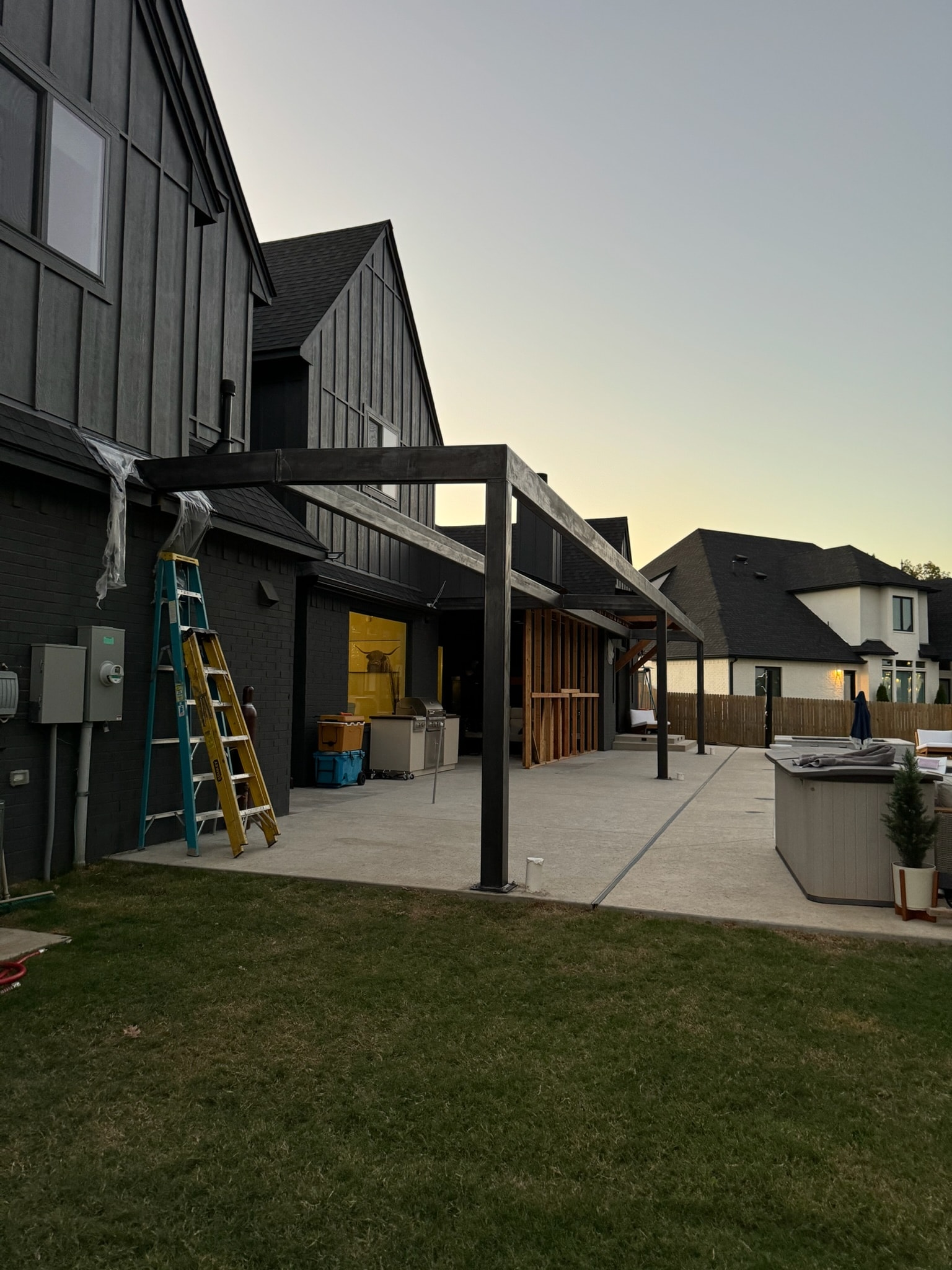 Custom steel patio pergola frame installed at a residential backyard