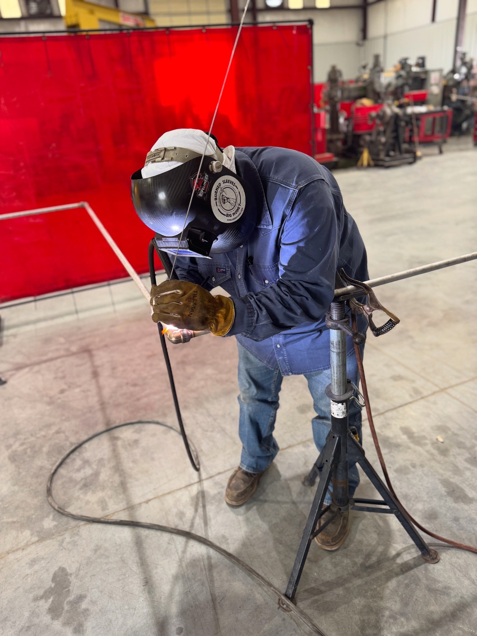Welder fabricating steel components inside the Claudio Welding shop