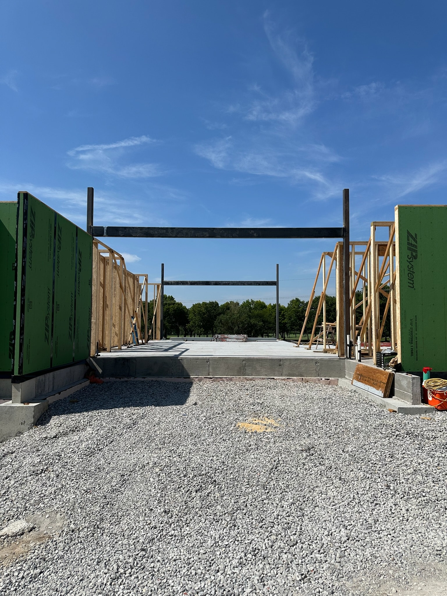 Structural steel entry frame installed between residential walls under construction