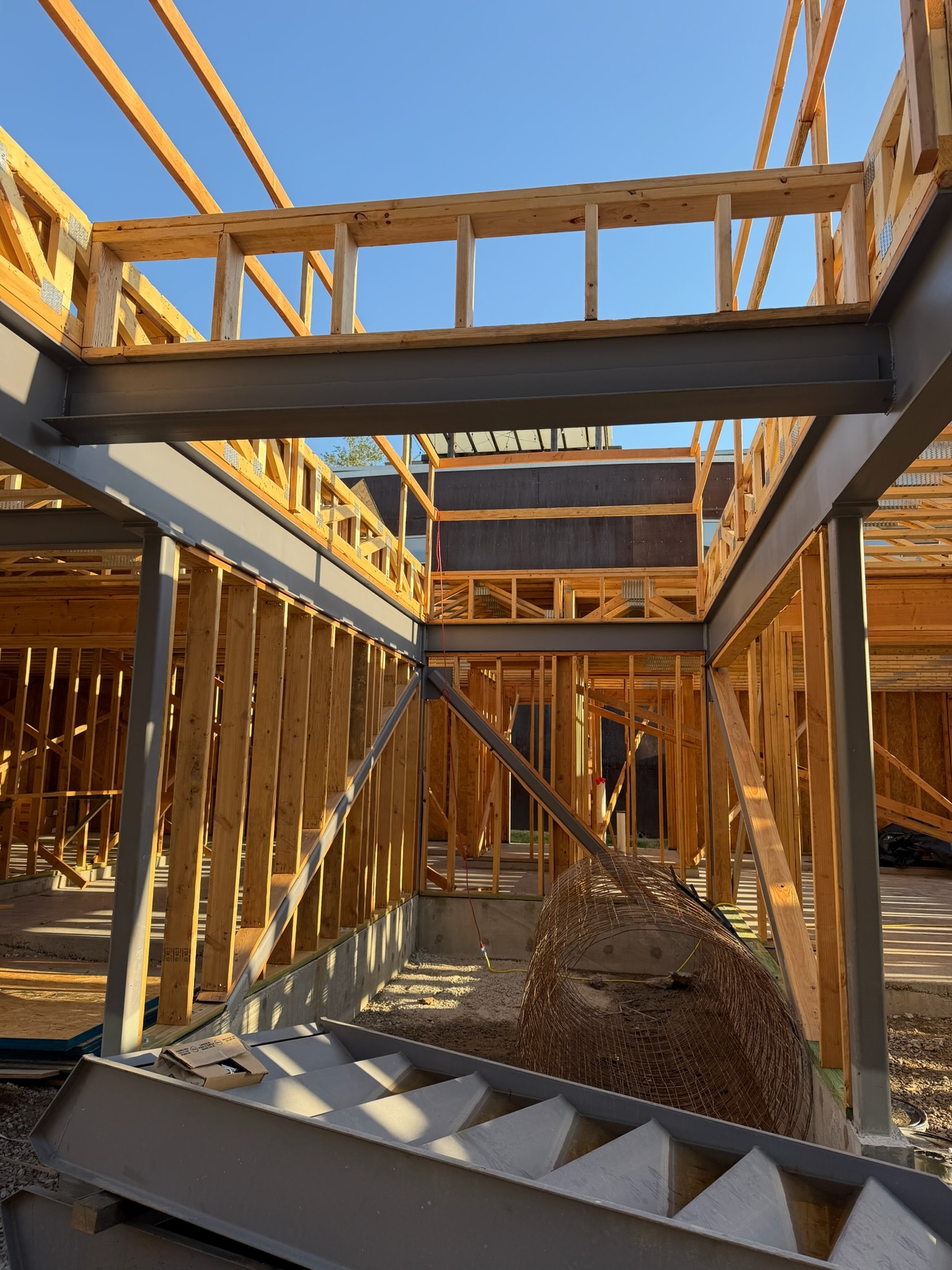 Structural steel beams integrated into a timber-framed building